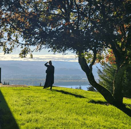 Author Debbie Ethell standing on top of Elephant Mountain looking out over a stunning landscape.