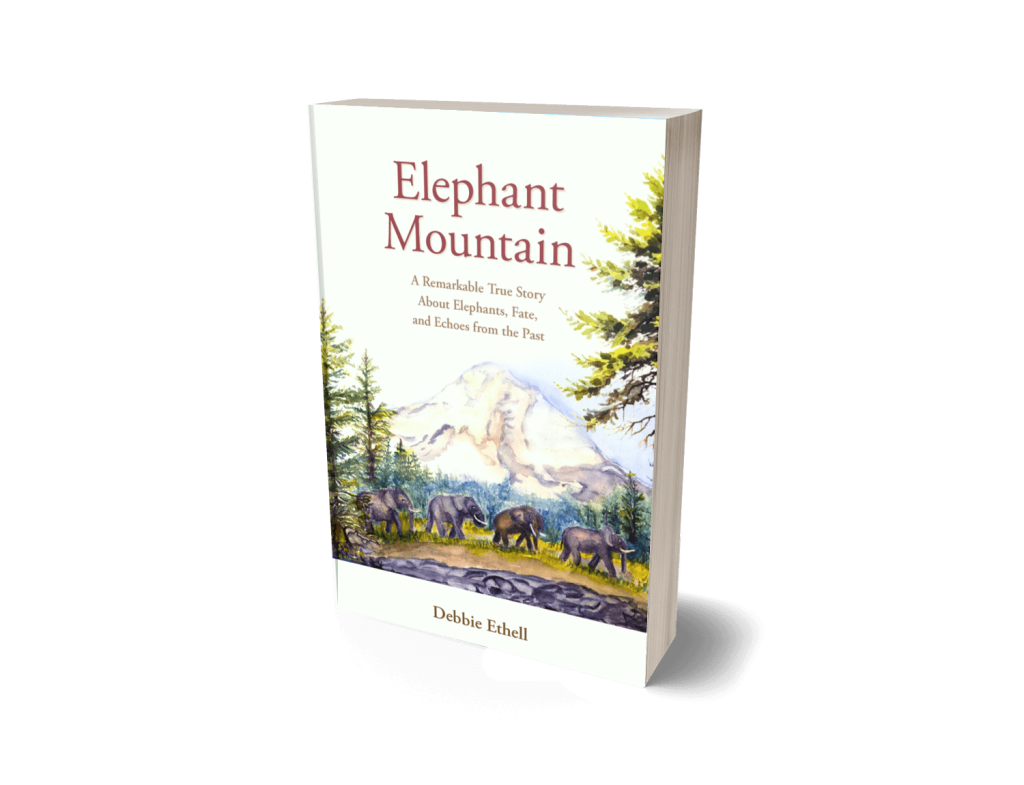 Book cover for Elephant Mountain nonfiction animal book by Debbie Ethell featuring a watercolor of elephants walking in a line below a mountain in the Pacific Northwest.