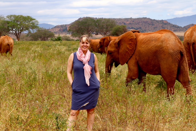 Debbie Ethell standing with wild elephants in Kenya, author of Elephant Memory and how remarkable the elephant brain is.